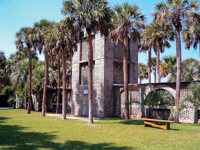 Atalaya Castle from the front with Palmetto trees in front.